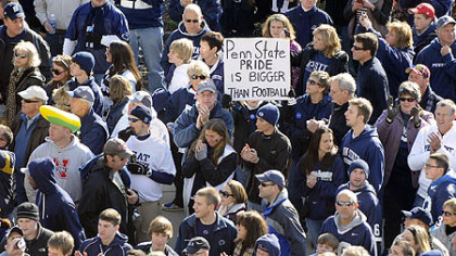 Fans line up outside Beaver Stadium to see their team enter the stadium before the start of their team's game against Nebraska today. One sign commented on the sex abuse reporting scandal that rocked the university this week and ended the coaching career of the legendary Joe Paterno.
