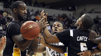 The view from the Pitt bench of the Panthers' loss wasn't easy to accept Wednesday at Petersen Events Center. Pitt's Nasir Robinson, middle, gets caught between Long Beach State's T.J. Robinson, left, and Michael Caffey.