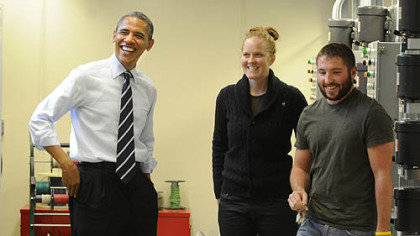 President Obama shares a laugh with IBEW second-year apprentices Cara Erskine and Ryan Cumberland during a tour of classrooms at the IBEW training center on the South Side.