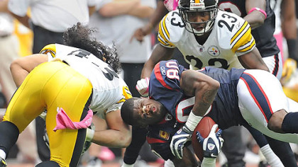 Steelers safety Troy Polamalu knocks the helmet off Texans receiver Andre Johnson.