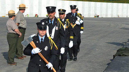 Shanksville Fire Department member Annie Daniels carries the axe as she marches with the department contingent during Sunday's ceremonies.
Sandee Eggleston, a retired United Airlines flight attendant supervisor, cries at the Flight 93 memorial.