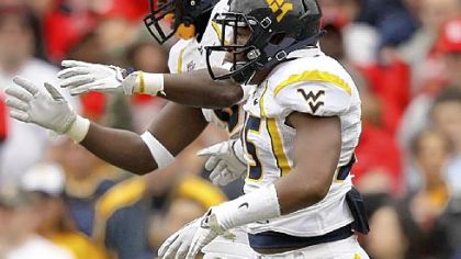 West Virginia's Darwin Cook and Keith Tandy celebrate a big play vs. Maryland.