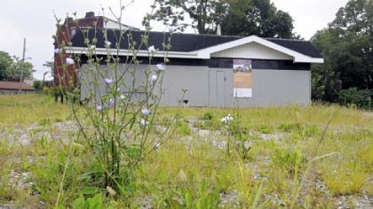 A vacant filling station occupies the corner lot of Larimer Avenue and East Liberty Boulevard. The three blocks between East Liberty Boulevard and Meadow Street have only nine buildings remaining.