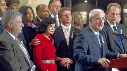 Rep. Kevin Murphy, D-Lackawanna County, center, comforts Rep. Louise Bishop, D-Philadelphia, after she spoke out for the first time about being a victim of child molestation by a relative when she was 12 during a rally Tuesday to strengthen Pennsylvania's child sex abuse laws at the Capitol in Harrisburg.