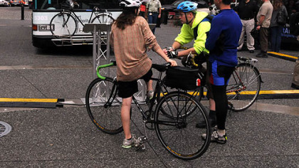 Cyclist check out one of the bike racks on a bus on Friday morning in Market Square.