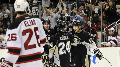 The Penguins' Jordan Staal is congratulated by Matt Niskanen, Matt Cooke and Richard Park after scoring a power play goal against the Islanders.