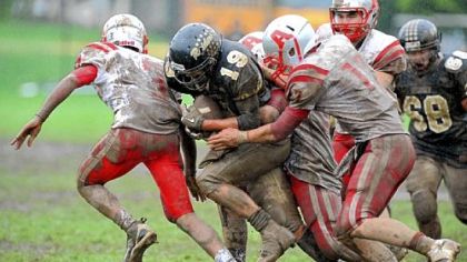 The Avonworth High School defense stops a run by Riverview's Tim Wagner, middle, on a rainy Saturday. The Antelopes shut Riverview out, 26-0.