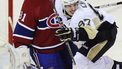 Sidney Crosby responds to a goal by teammate Pascal Dupuis against Canadiens goalie Carey Price.