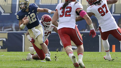 Pitt quarterback Tino Sunseri is tripped up by Utah's LT Tuipulotu in the second quarter at Heinz Field this afternoon.