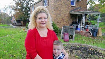 Tracey Clark and her 5-year-old son, Alexander, in front of their home in Bethel Park.