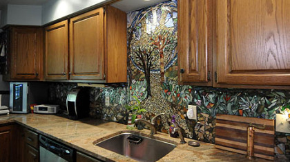 The kitchen features a glass mosaic backsplash created by local artist Daviea Davis.