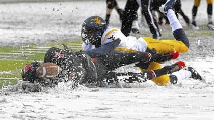 Rutgers' Quran Pratt, left, can't hold onto a pass in the snow after being hit by West Virginia's Pat Miller.