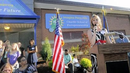 Kristen Priganc, right, principal of the new Imagine Penn Hills Charter School of Entrepreneurship, speaks Monday at the school's open house. The school, open in the former William Penn Elementary building, has 202 students in kindergarten to the second grade.